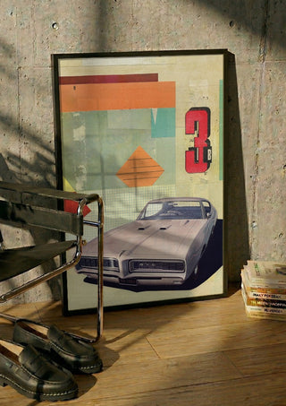 GTO 3 by Kareem Rizk in a black frame leaning against a concrete wall by a steel chair