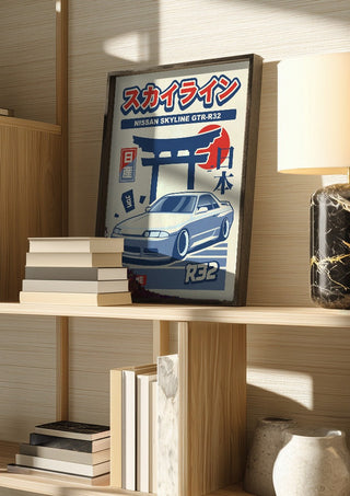 Nissan Skyline GT-R R32 by Kaminarirace in a dark frame on a wooden shelf beside books and a lamp