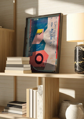 Abstract Composition No.2 by Kareem Rizk in a dark frame on a wooden shelf beside books and a lamp