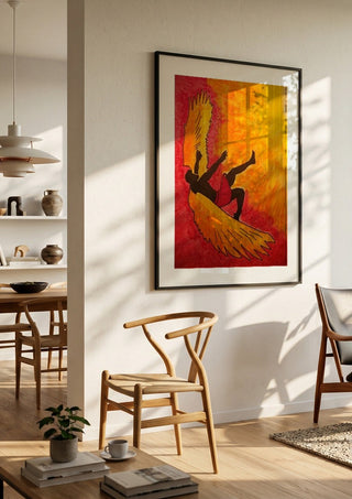 Manie oder der Flug des Ikarus by Olaf Baier in a black frame in a bright dining room with wooden chairs