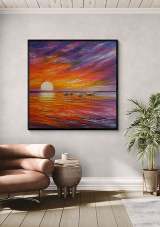 Colorful by Sunny in a black frame above a pink armchair beside a potted palm