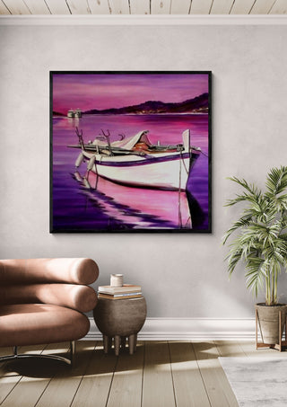 Boat in Pink by Sunny in a black frame above a pink armchair beside a potted palm