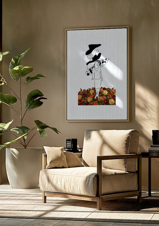 The weight of the world by Madame Petit framed above a beige armchair beside a potted plant