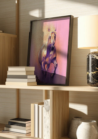 Wild by Sabrina Rosenblatt in a dark frame on a wooden shelf beside books and a lamp