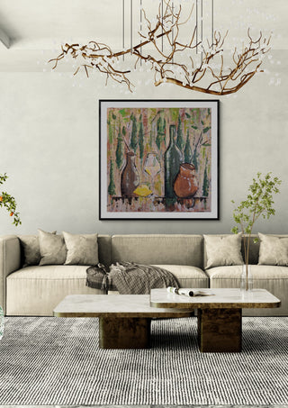 Summer mood by Dina in a black frame above a beige sofa under a branch chandelier
