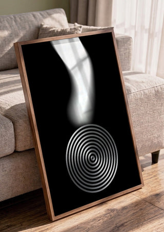 Echo by Aleksi Allan in a walnut frame leaning against a grey sofa