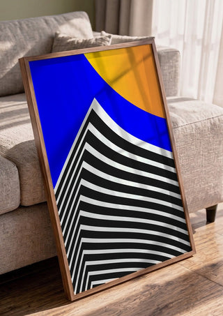 Pyramid by Aleksi Allan in a walnut frame leaning against a grey sofa