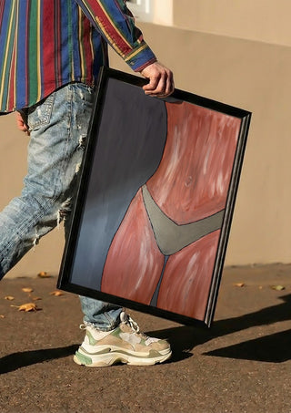 Bare Confidence by Bibi carried in a black frame along a sunny street