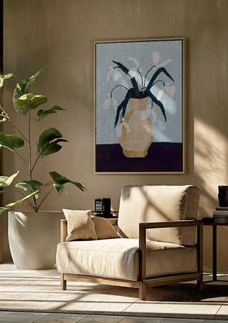 Vita blomster i beige vas by Rebecka Hansson framed above a beige armchair beside a potted plant