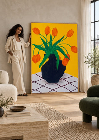 Orangea blomster i brun vas by Rebecka Hansson in a tall wooden frame leaning against a wall in a sunlit room