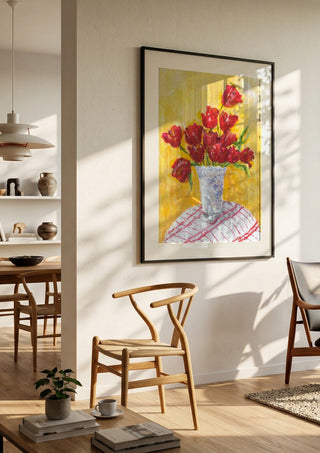 Tulips - II by Deblina Dey in a black frame in a bright dining room with wooden chairs