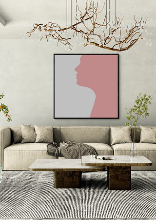Pure by Tonia in a black frame above a beige sofa under a branch chandelier