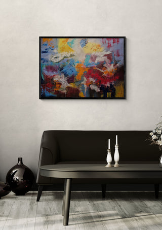 Symphony of colour by Sabine Halbrock in a black frame above a dark sofa with white candlesticks