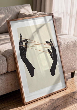 Unclear plans by Nari in a walnut frame leaning against a grey sofa