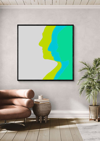 Balance by Tonia in a black frame above a pink armchair beside a palm