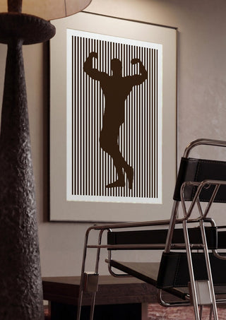 bodybuilder silhouette by nyai framed in a dim room beside a tubular steel chair