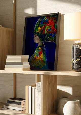 The Wind by Ronny Simon in a dark frame on a wooden shelf beside books and a lamp