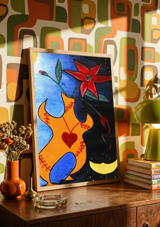 Human Vase by A Sleepy Spirit Art in a wooden frame on a sideboard against retro patterned wallpaper