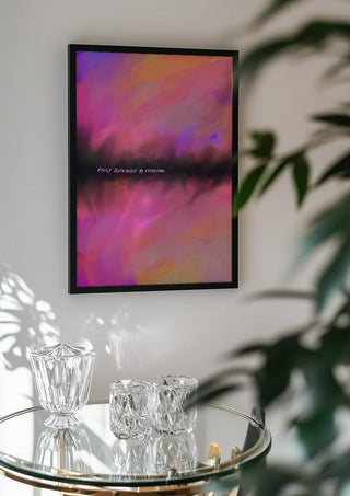 Easily distracted by everything by Astrid Lind in a black frame above a glass table with crystal glassware
