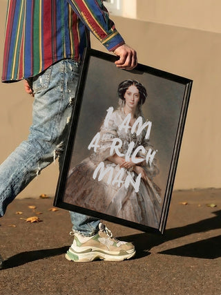 Person holding "Elegant Rich Man Portrait - Talitha McQueen" with bold text reading "I AM A RICH MAN."