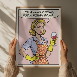 Framed Human Being Pop Art by Andreas Magnusson showing a woman with gloves, apron, and wine glass, pop art style.