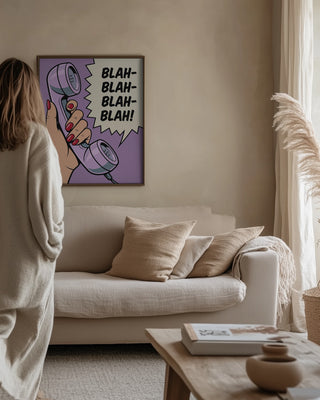 Blah Blah Blah artwork by Andreas Magnusson hanging above a beige sofa in a cozy, neutral-toned living room.