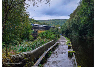 Wet Towpath by the Railway by Northern Gnome Photography - wet cobbled towpath beside a canal with a train in the distance