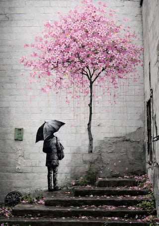 Spring x Banksy by Decker Studios - figure with an umbrella beneath a pink blossom tree on a brick wall