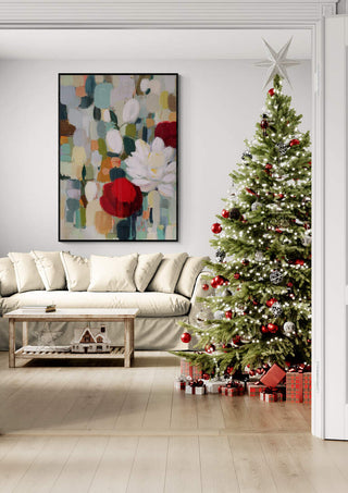 Elegant Christmas living room with a decorated tree, wrapped gifts, and festive floral wall art.