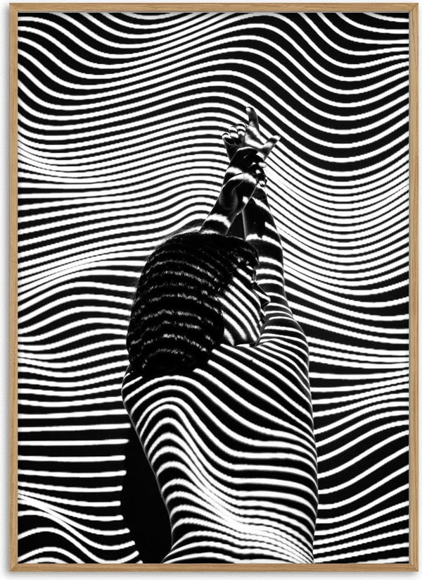 A model in black and white fashion poses with abstract striped patterns creating a bold visual effect.