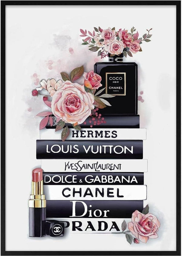 Chanel perfume, lipstick, and roses displayed on stacked books featuring top fashion brands’ names.