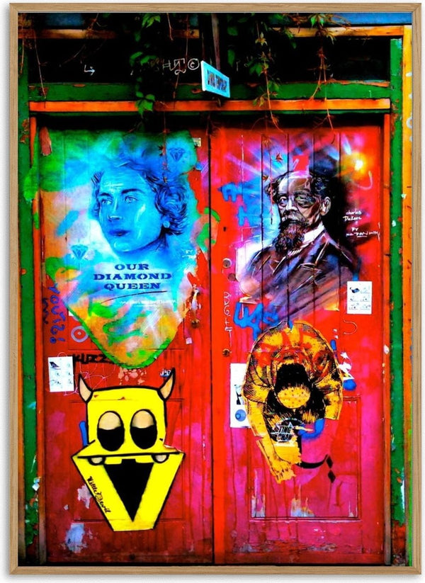 Graffiti Door by Pelecan Schneider - red London door covered in spray-painted portraits, a yellow monster and tags