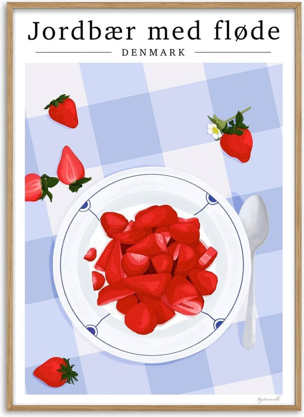 A plate of sliced strawberries on a blue checkered tablecloth, with whole strawberries and a spoon nearby.