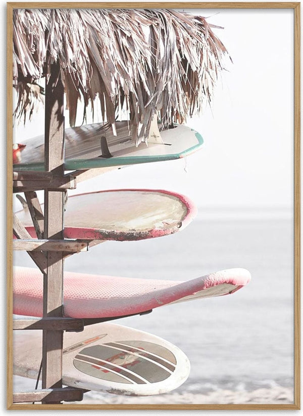 Four surfboards stacked under a thatched roof by the beach, displayed on Surfboards on Beach Plakat.