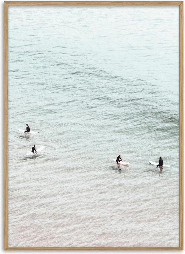 Four surfers on surfboards sit in calm, pale water seen from above for Surfers in Water Plakat.